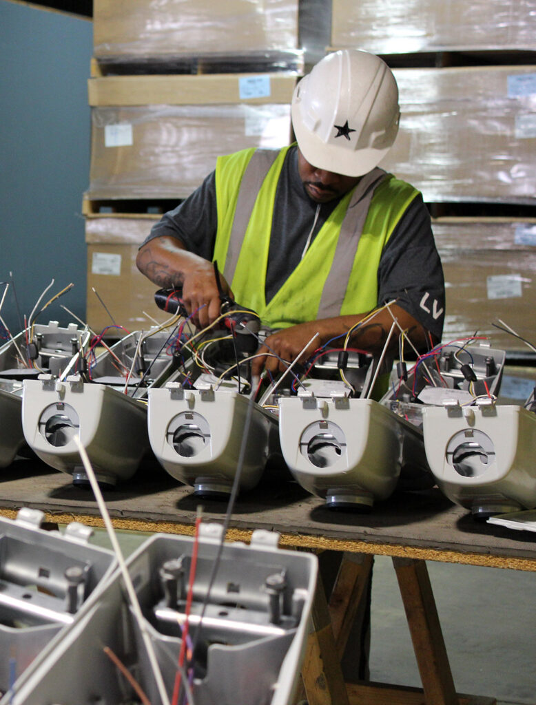 The Will Group team member assembling lighting fixtures at K-Town Business Centre