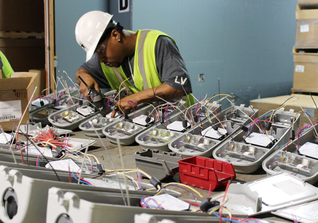 The Will Group employee assembling assemble lighting fixtures used in the City of Chicago’s Blocks Program.